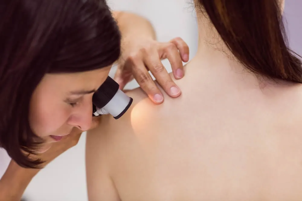 dermatologist-examining-skin-patient-with-dermatoscope
